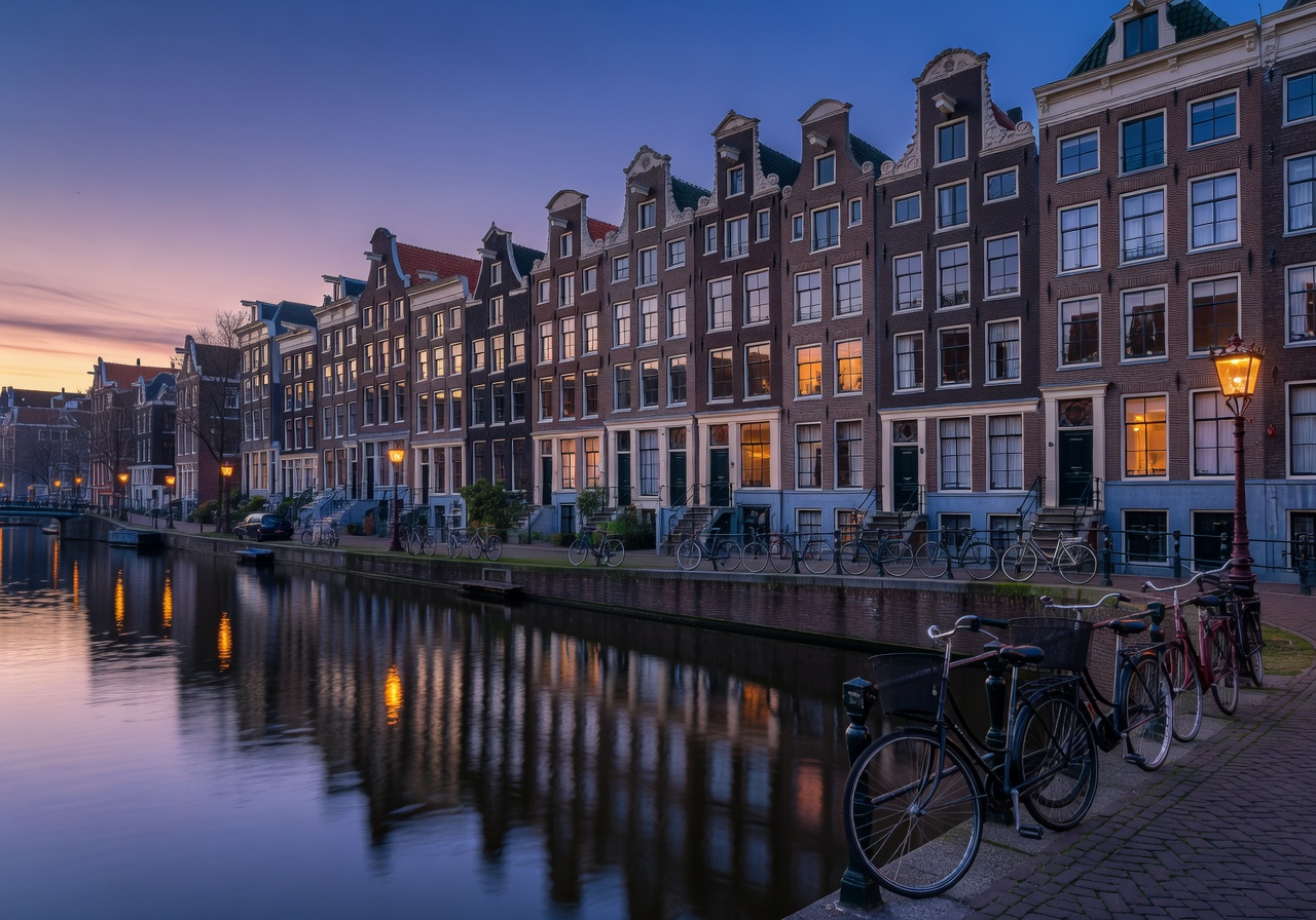 Charming canal houses and bicycles along Amsterdam waterways at dusk